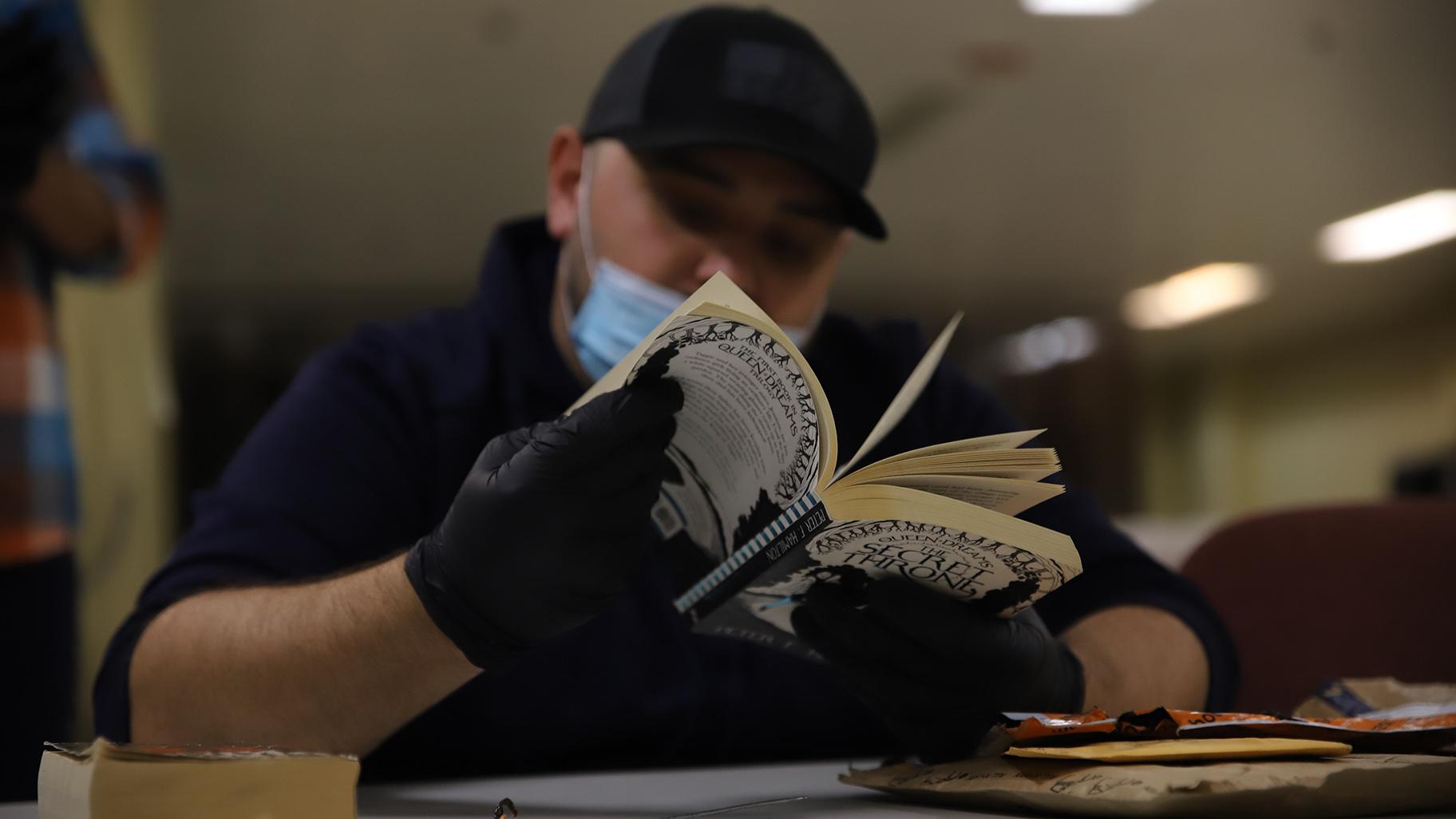 Jail personnel go through stacks of letters and books in the mail room at Cook County Jail on Oct. 12, 2023. All mail coming into the jail has faced greater screening methods since the paper restriction began in April. (Cary Robbins / DePaul)