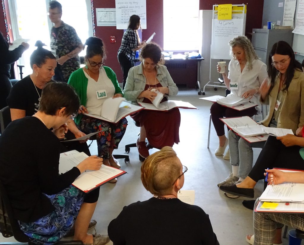 Women sit in a circle as part of a class at GVI 