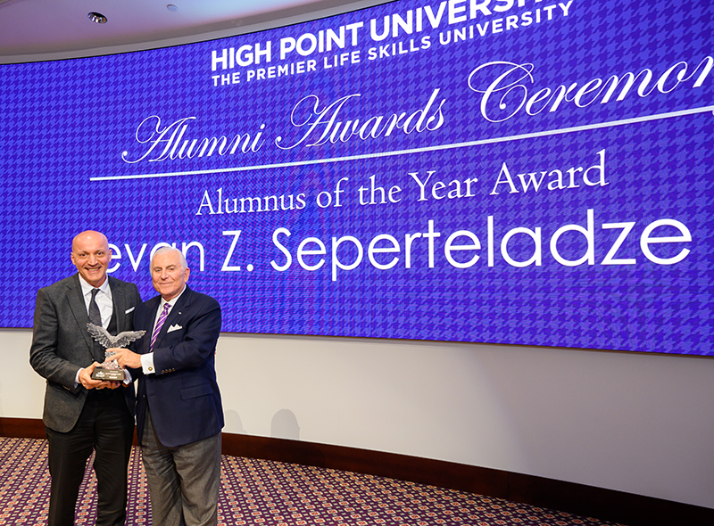 Levan Z. Seperteladze, Class of 1995, left, with the Alumnus of the Year Award presented by HPU President Nido Qubein, right.