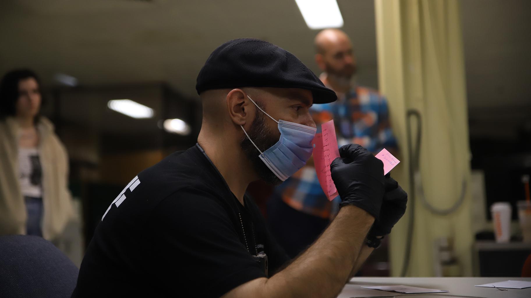 Jail personnel go through stacks of letters and books in the mail room at Cook County Jail on Oct. 12. All mail coming into the jail has faced greater screening methods since the paper restriction began in April. (Cary Robbins / DePaul)