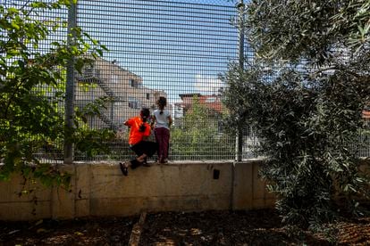 Ruba Ghryib, 10 years old (left), and her sister Haya, 8, look out at the house that Jewish settlers built on the land of this Palestinian family and that has left their home absorbed by the Israeli settlement of Givon Hahadasha.