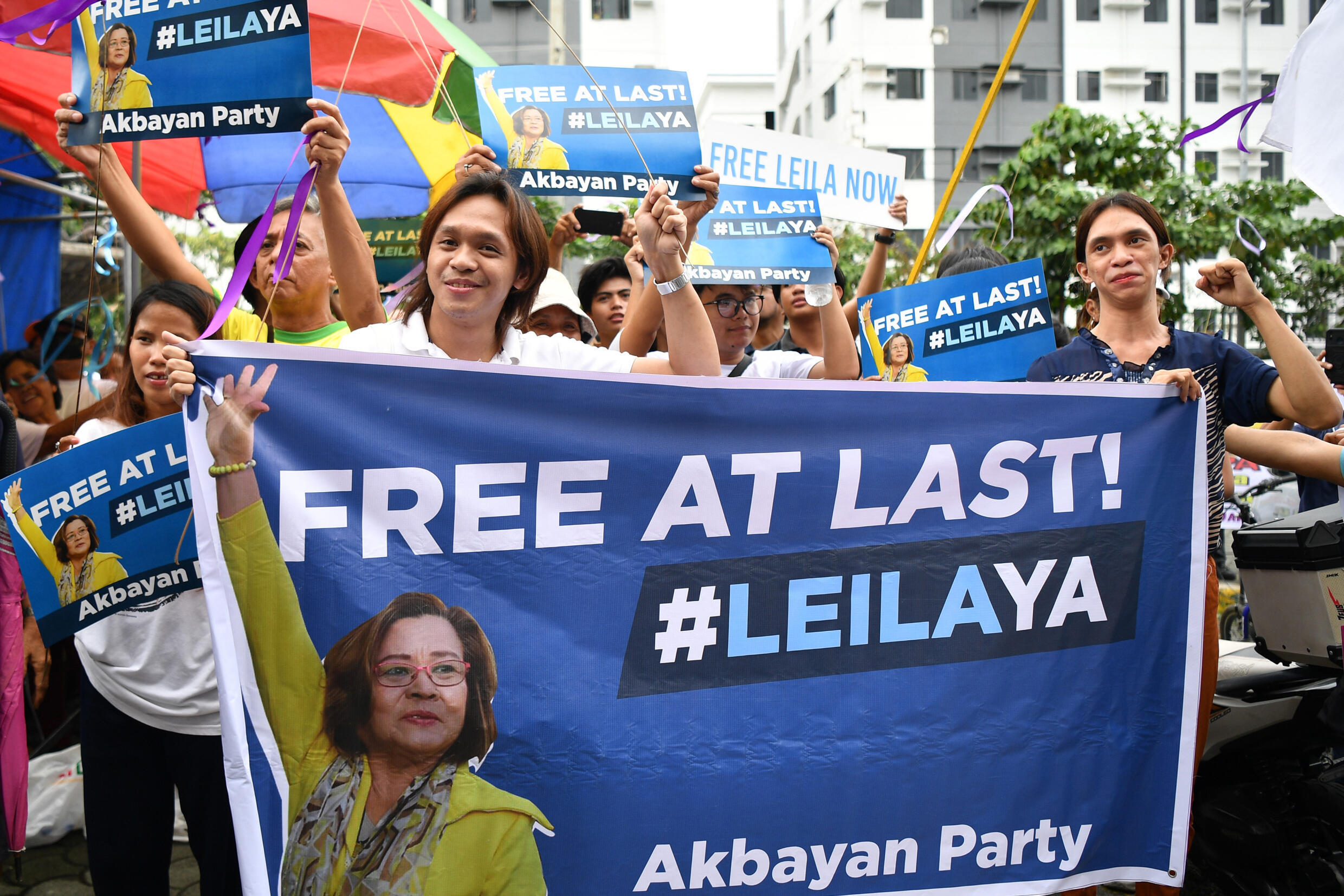 Supporters of De Lima celebrate outside the court. De Lima was jailed on narcotics-related charges she says were fabricated to silence her