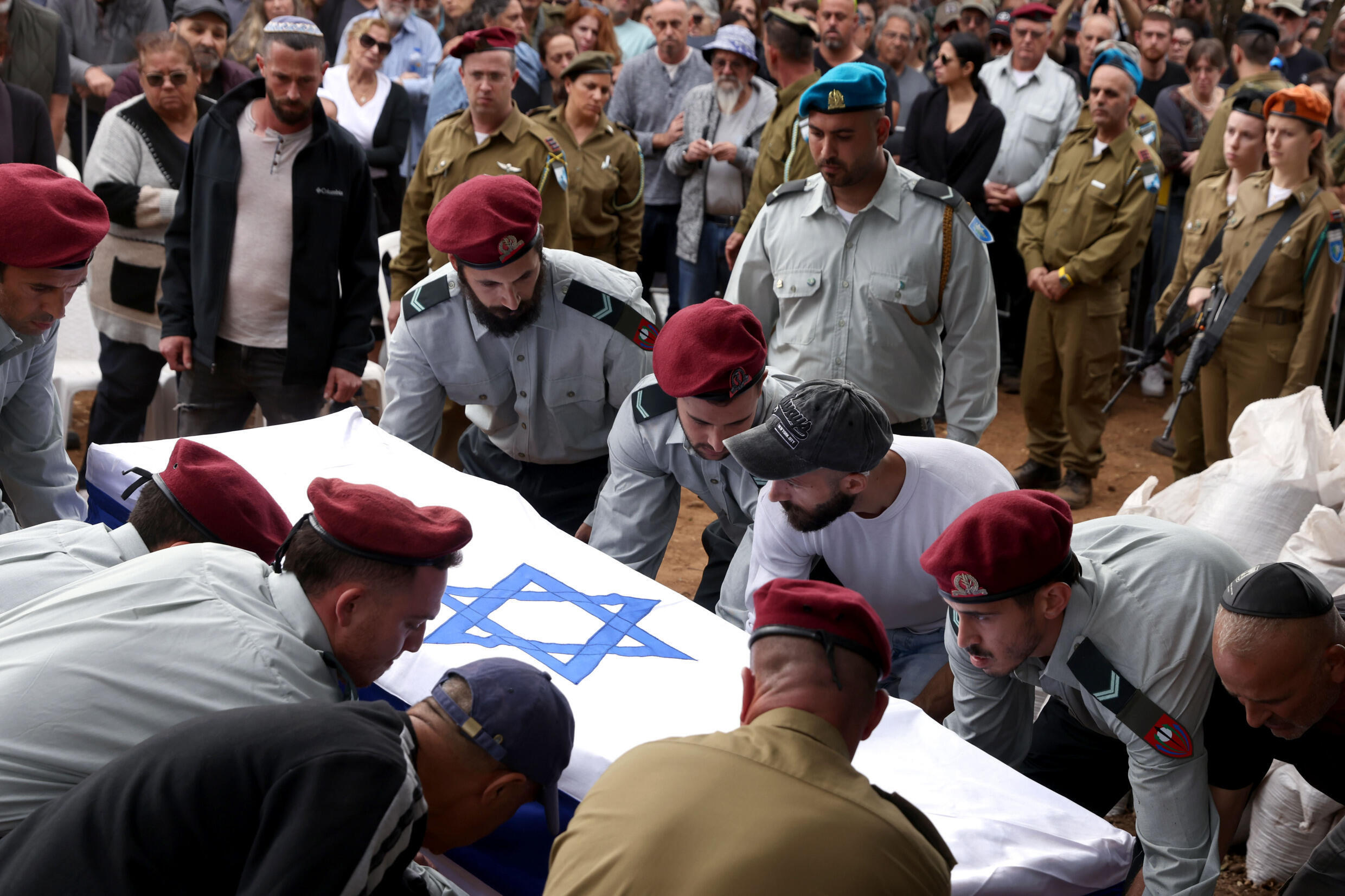 Israeli soldiers and civilians attend the funeral of Matan Meir, a member of the 