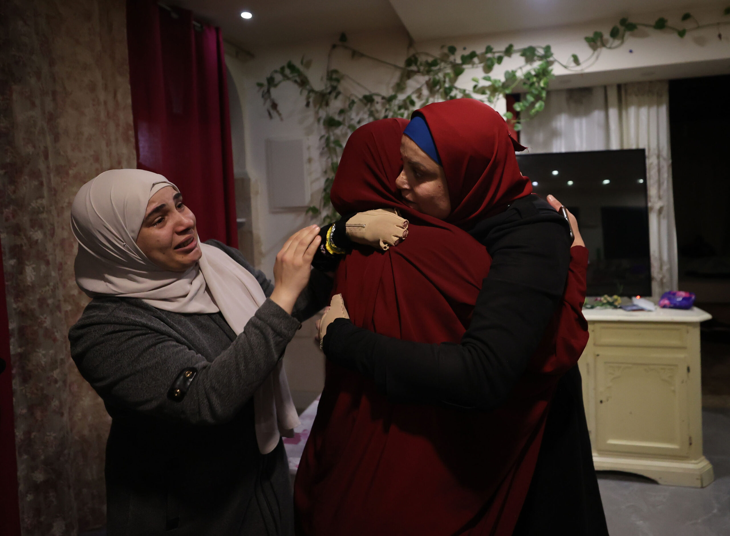Israa Al-Jaabis reunites with her family in East Jerusalem early Sunday after being released from an Israeli prison. 