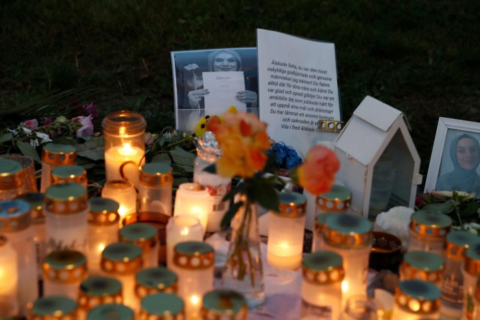 A memorial site with candles, flowers and words of remembrance for Soha Saad