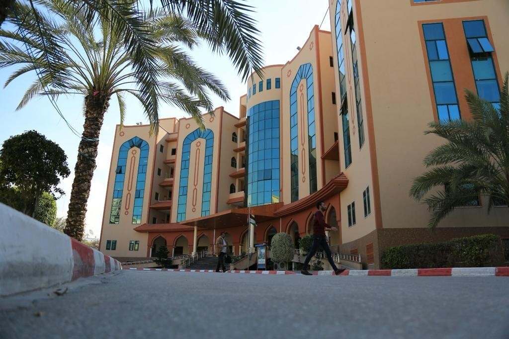 The front of a large building, seen from a distance.