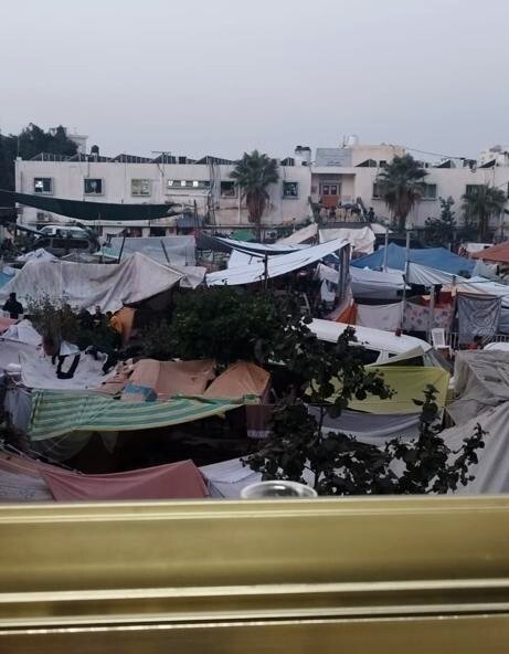 A large number of makeshift tents, seen from an elevated window