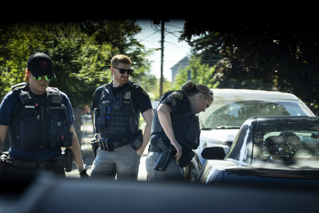 Three Portland Police officers interrupt a 