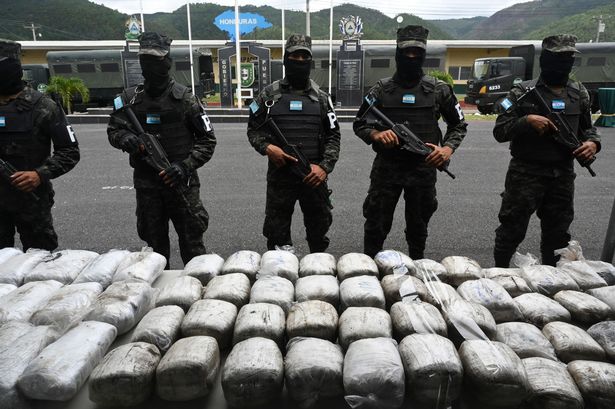 Members of the Military Police of Public Order (PMOP) guard drugs seized from Barrio 18 and MS-13 gangs in Honduran prisons