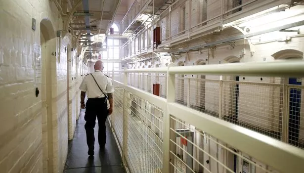 A guard walking inside prison