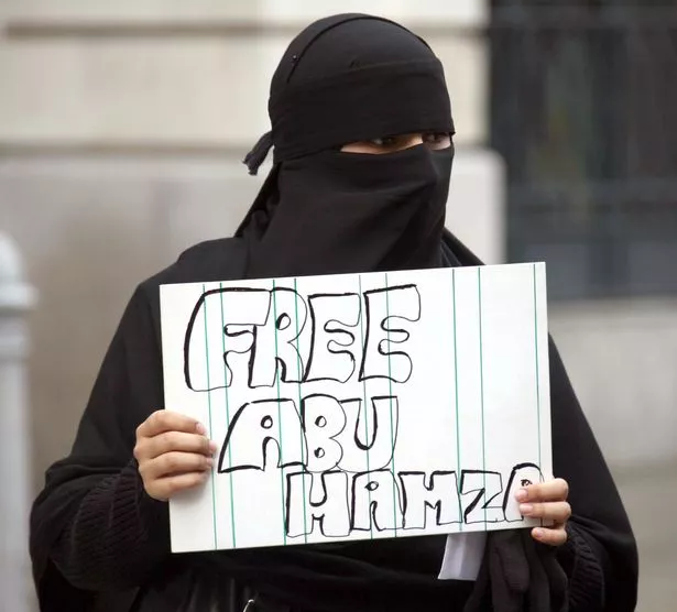 A protestor with a placard 'Free Abu Hamza' outside the Old Bailey