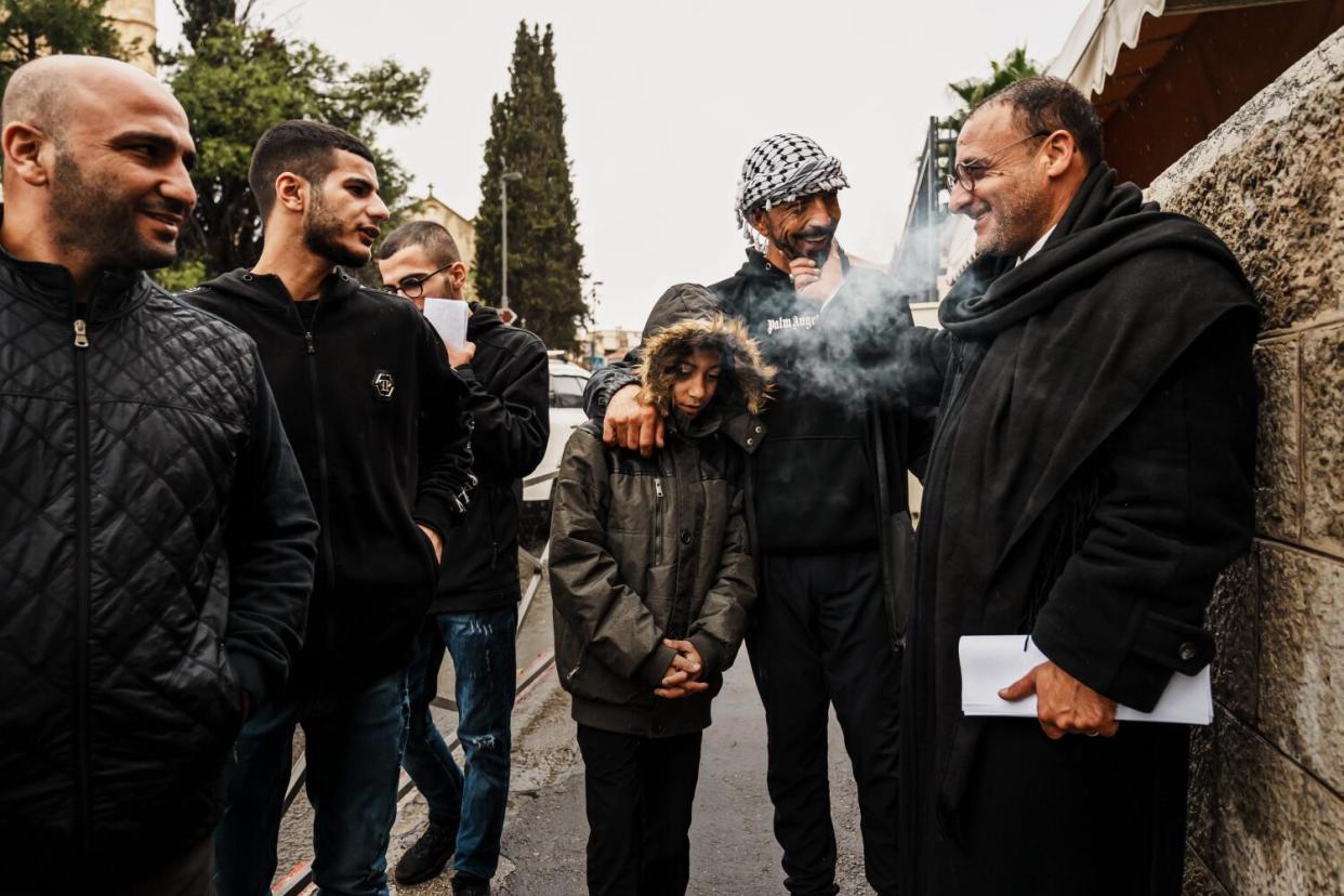 Attorney Mohammad Mahmoud, from right, speaks with Nawaf Salaymah and his son Ayham Salaymah, 13.