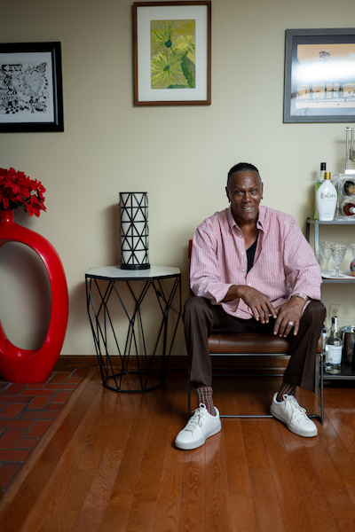 Richard Phillips smiles while seated in a chair at home