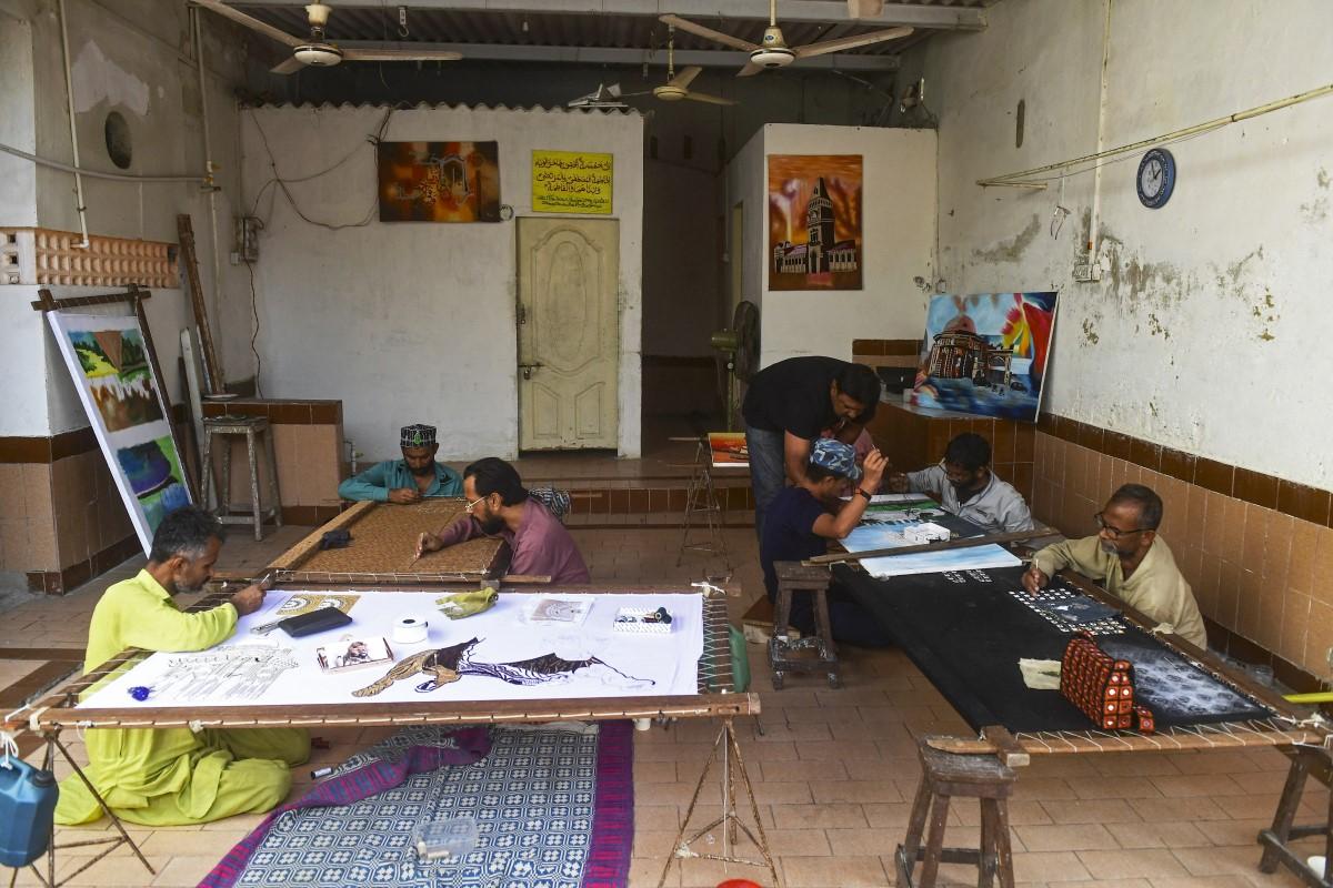 Ijaz (third right), an artist and a former convict, guides his students at the central jail in Karachi on December 16.