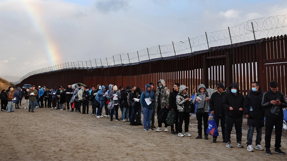 Asylum seeking migrants waiting in line