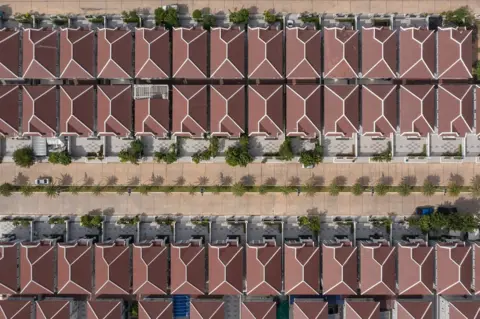 Thomas Cristofoletti/ BBC Aerial view of a recently built gated community “borey” on the outskirts of the capital Phnom Penh