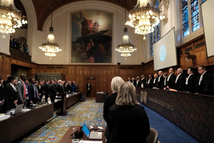 Judges and parties stand during a hearing at the International Court of Justice