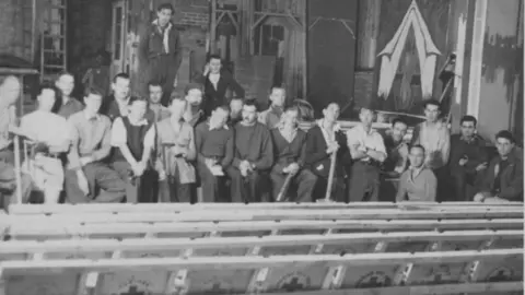 National Archive Peter Butterworth (standing at the back) with the theatre company at Stalag Luft 3