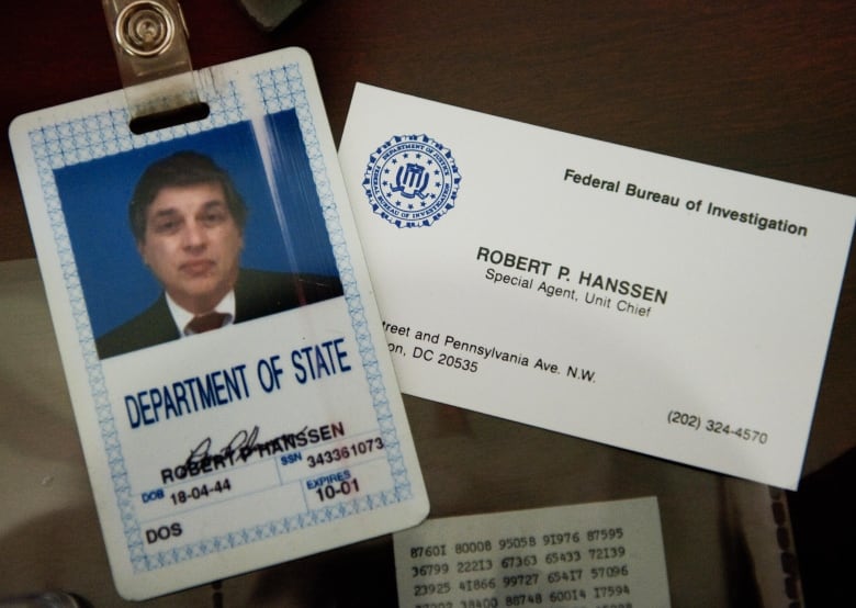 The ID badge and business card of former FBI agent Robert Hanssen are seen on display at the FBI Academy in Quantico, Va., in 2009.