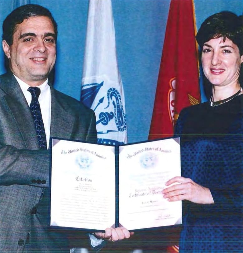 George Tenet, the former U.S. Director of Central Intelligence, is seen presenting a certificate to Ana Belén Montes.