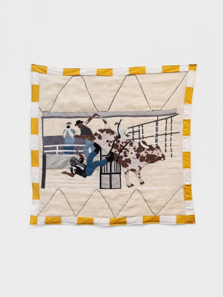 a quilt showing a picture of a man falling off a bull at a rodeo