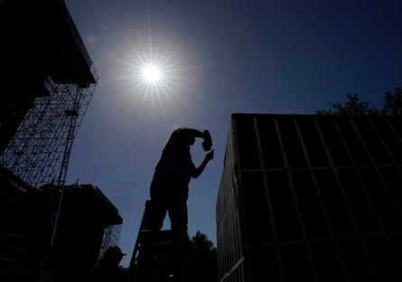 Silhouette of person standing and holding a drill