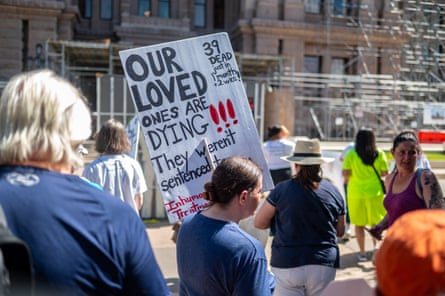 People holding signs walk forward