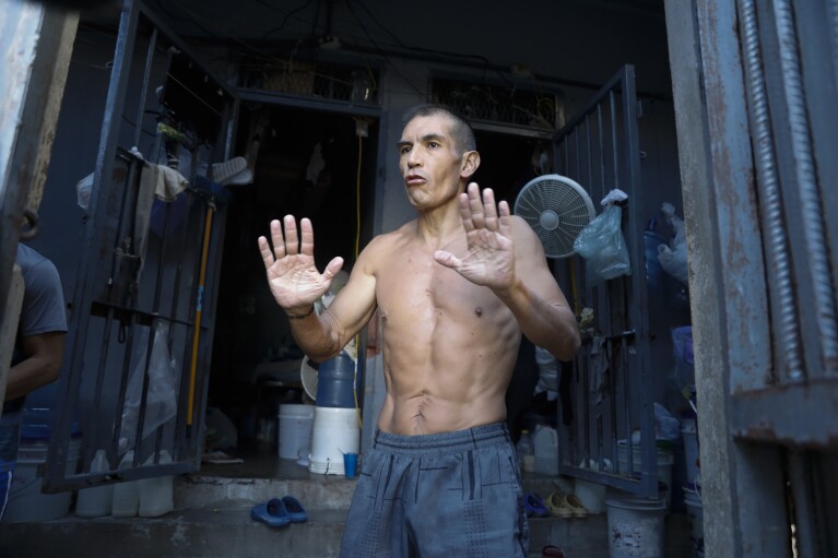 ADDS NAME - Former Colombian soldier Carlos Guerrero, accused of participating in the assassination of Haitian President Jovenel Moise, speaks with journalists inside the National Penitentiary in Port-au-Prince, Haiti, Sunday, March 3, 2024. Hundreds of inmates have fled Haiti's main prison after armed gangs stormed the facility overnight. (AP Photo/Odelyn Joseph)