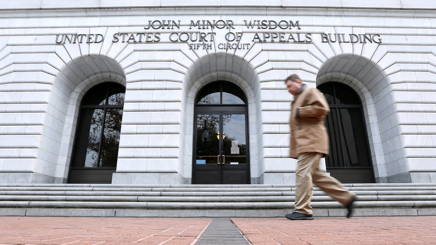 A man walks in front of the 5th U.S. Circuit Court of Appeals, Wednesday, Jan. 7, 2015, in New Orleans.