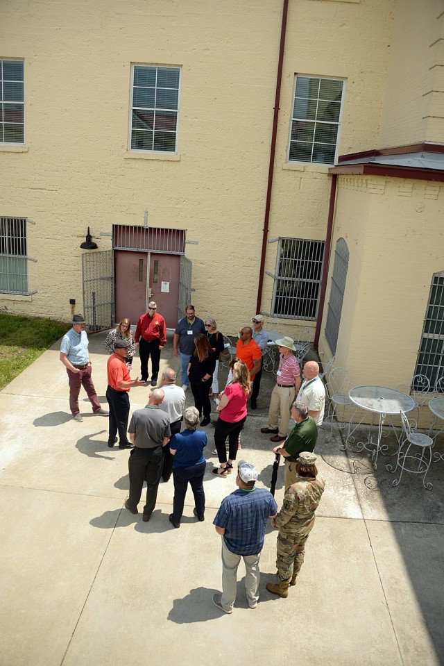 Retired 1st Sgt. Michael Jones leads a tour group through the grounds of the Old U.S. Disciplinary Barracks May 21, 2024, starting outside 12th Brick Grille at Fort Leavenworth, Kansas. Photo by Prudence Siebert/Fort Leavenworth Lamp