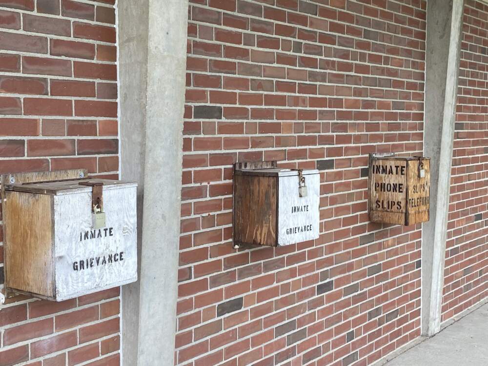 Boxes labeled "inmate grievances" seen in the prison yard at MCI-Concord. (Deborah Becker/WBUR)