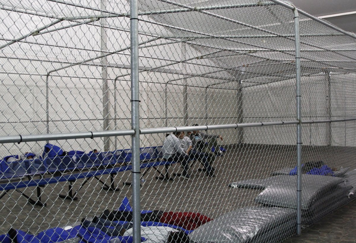 Migrants are detained in a cage