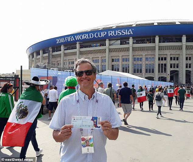 A smiling Marc Fogel pictured holding his match day ticket in front of Luzhniki stadium before a World Cup match in 2018