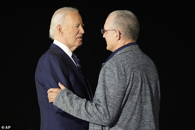 He is seen greeting Biden here, before being reunited with his family