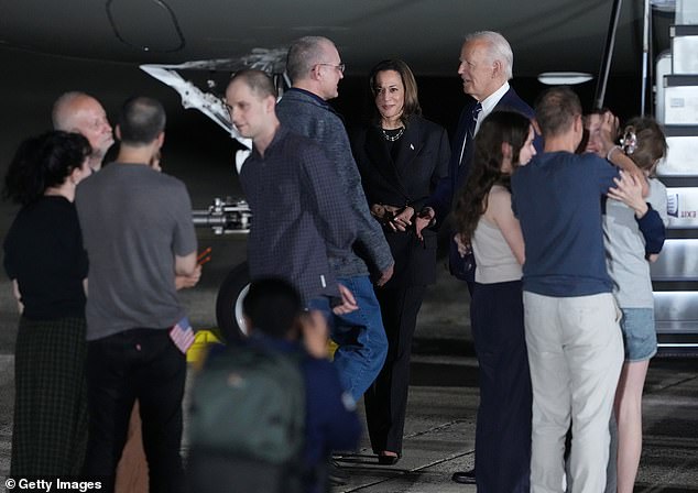 He had been wrongly accused of espionage, and was detained in Russia while working as a journalist on March 29 of last year. Fellow freed hostage Paul Whelan is seen meeting the president and vice president in the background