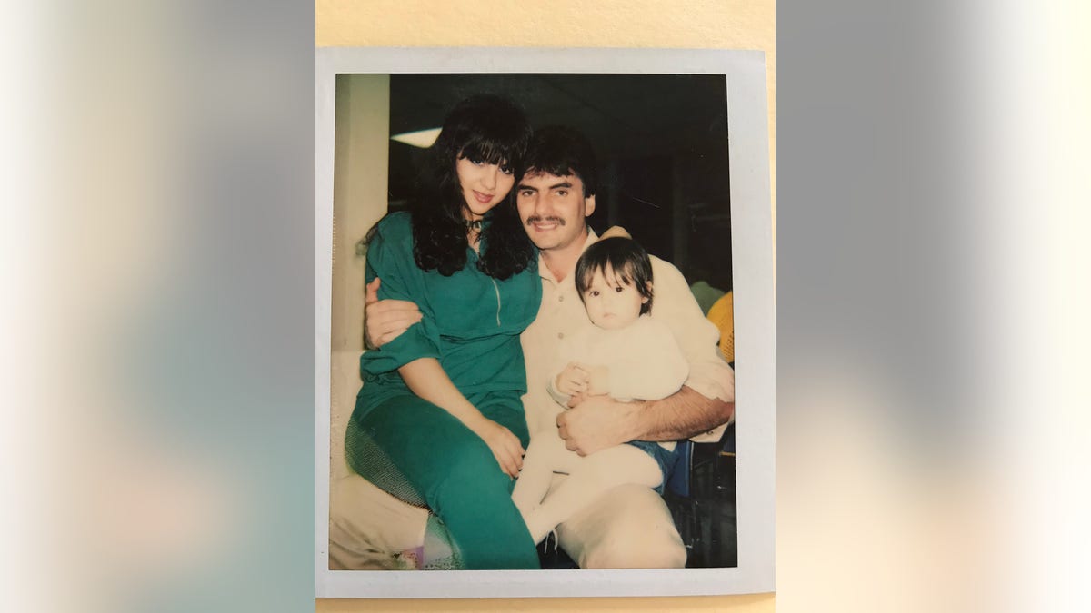 Michael Franzese holding his wife Camille and baby daughter.