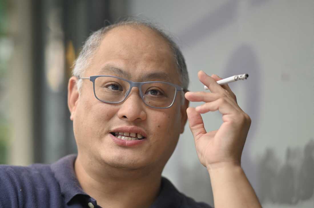 Taiwanese democracy activist Lee Ming-che speaks with friends before an interview with Agence France-Presse in Taipei on Oct. 5, 2022. Lee returned home in April 2022 after being jailed in China for five years following a national security conviction that further strained already tense relations between Taipei and Beijing.