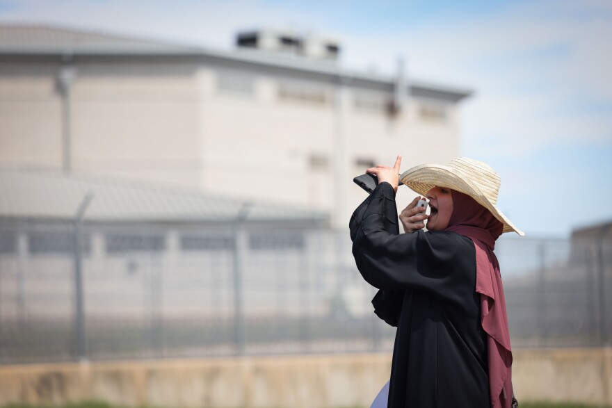 Miriam H. leads the chanting of protesters for Aafia Siddiqui outside FMC Carswell on Sunday, Sept. 22, 2024, in Fort Worth.