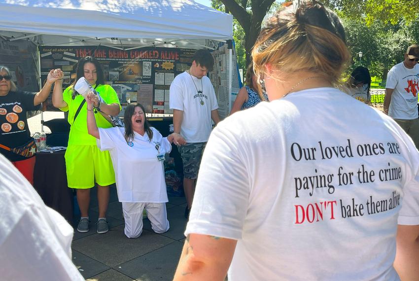 Tona Southards, whose 36-year-old son died in a Texas prison during the June 2023 heat wave, falls to her knees as she leads a prayer circle outside the Texas Capitol on July 18, 2023. Southards and other prison rights advocates called for Gov. Greg Abbott to call a special session to install air conditioning in Texas prisons.