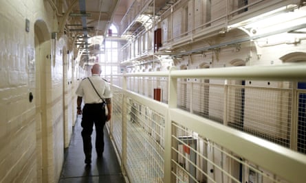 An officer walks through a prison wing