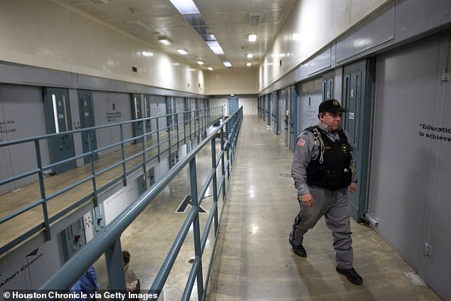 An investment into educational and drug treatment programmes for prisoners saw the US state decrease their prison population by 15 per cent. Pictured: A guard walks through a prison in Huntsville, Texas