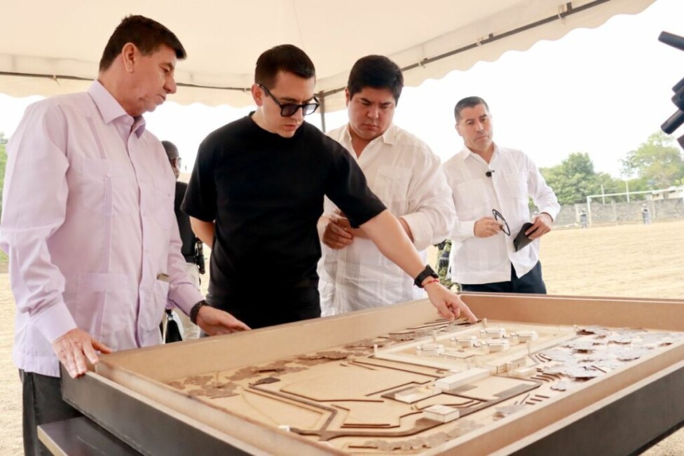 Ecuadorian president Daniel Noboa (in black) looks at a model of the new maximum security prison being built on his country's Pacific coast. He presents it as part of the fight against criminal gangs he describes as terrorists. Credit: Presidencia de Ecuador