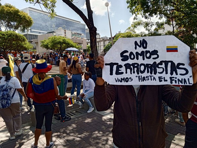 &quot;We are not terrorists,&quot; reads a sign held by a protester in Caracas against the proclaimed re-election of president Nicolás Maduro. Nearly 2,000 people have been arrested in the protests and the Attorney General's Office has announced terrorism charges against hundreds of them. Credit: Provea