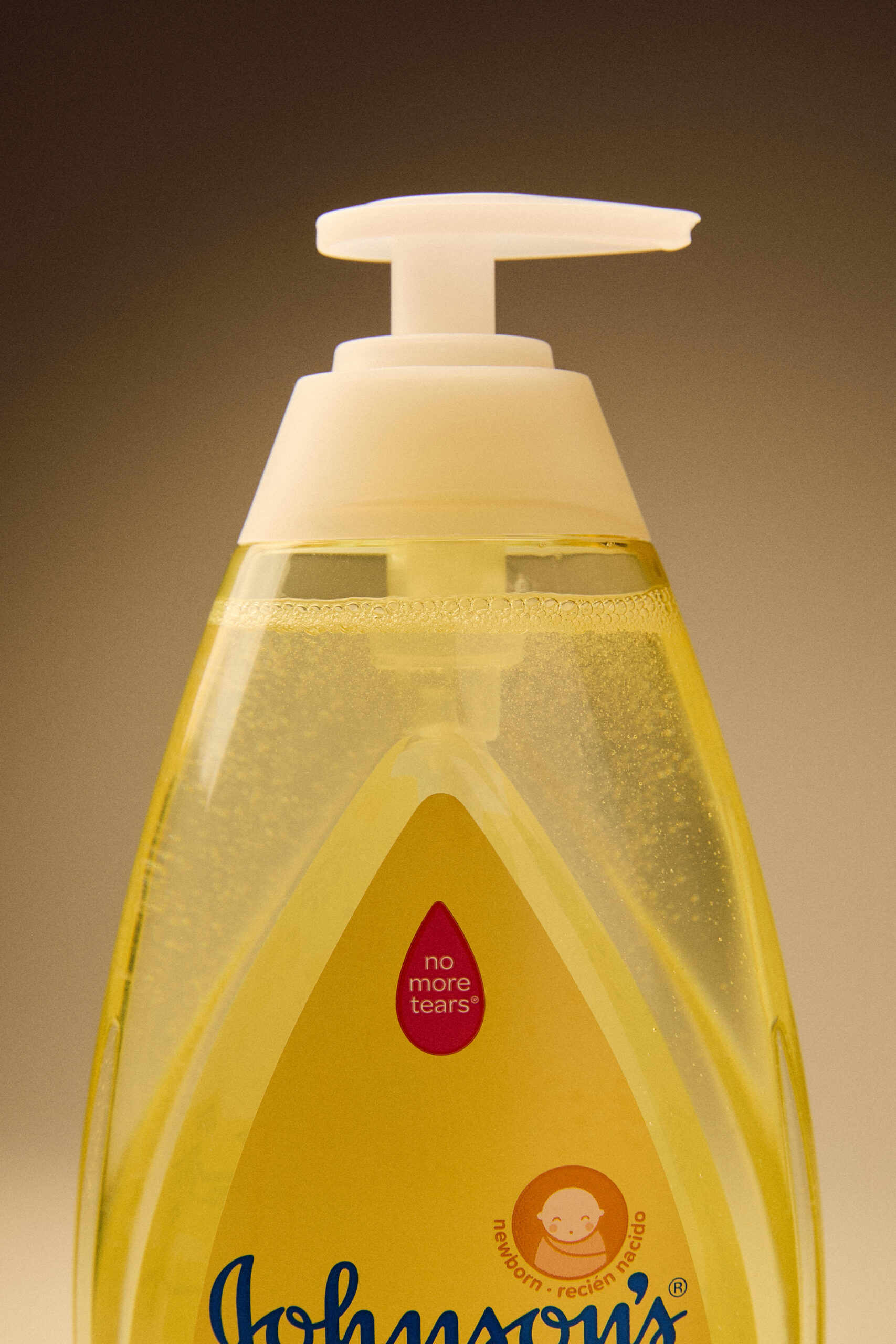 A studio shot of a yellow Johnson & Johnson baby wash bottle.