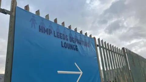 Steve Jones/BBC A sign at Leeds Prison which reads HMP Leeds Departure Lounge