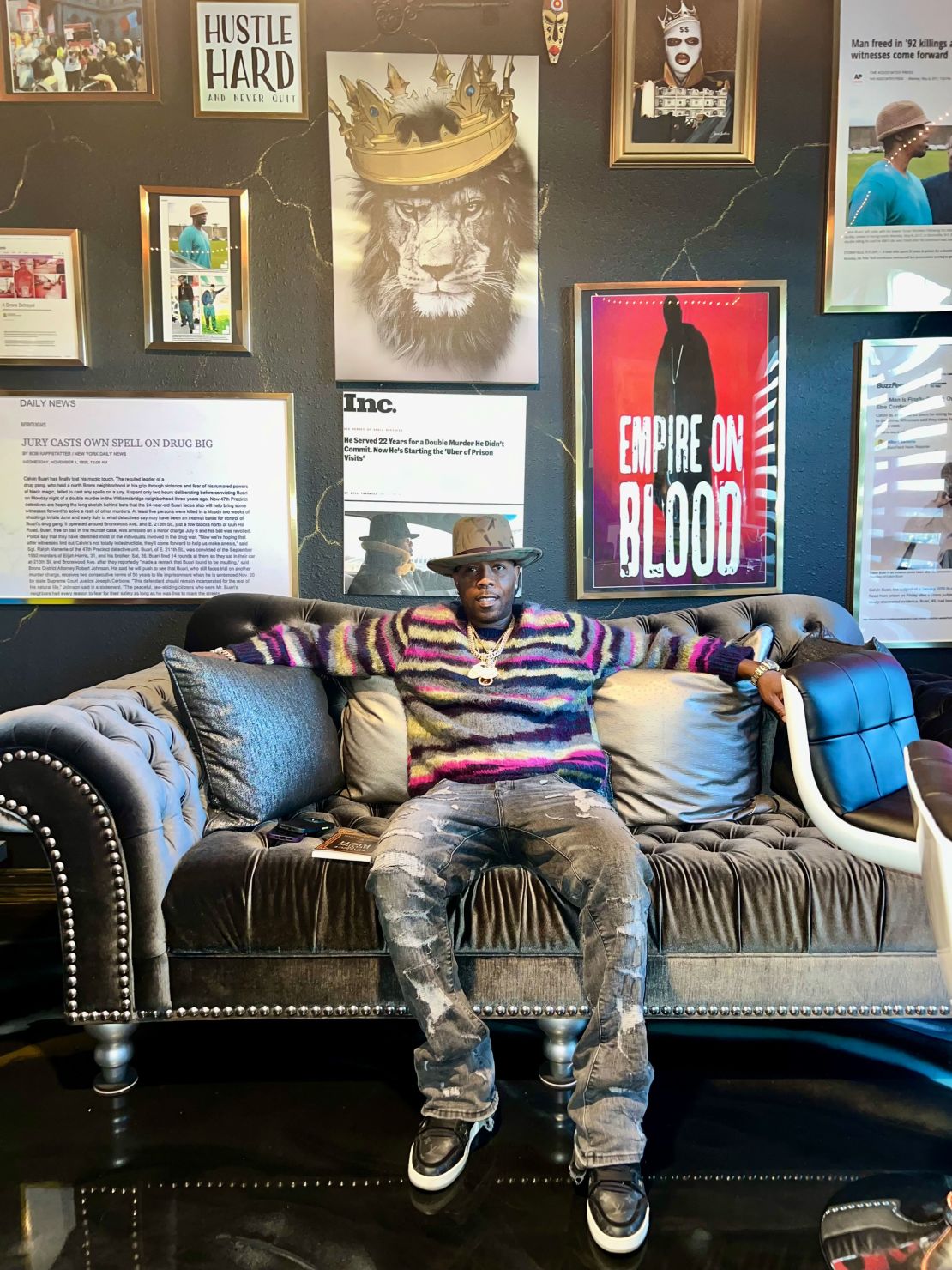 Calvin Buari in his home outside Houston, Texas. He's hung framed mementos from his case on the walls.