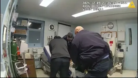 New York State Attorney General's Office Screenshot of bodycam footage showing officers holding down Robert Brooks in a prison infirmary.