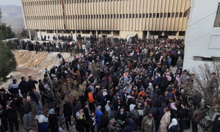 People gather at the Sednaya prison in Damascus as Syrian rescuers search the jail, 9 December 2024.