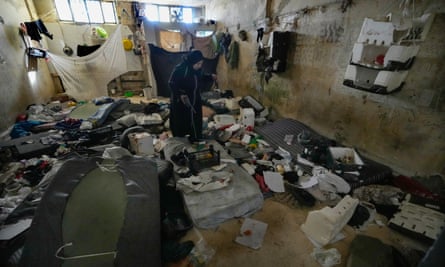 A woman looks around a room at Sednaya prison on 9 December.