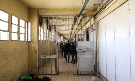 An image of the inside of the prison, showing dilapidated walls and rusty gates